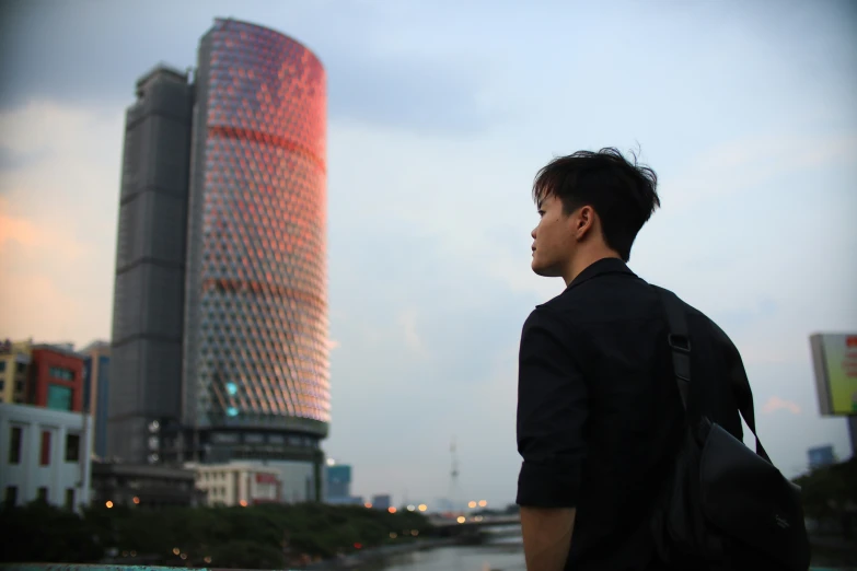 man standing near body of water in urban setting