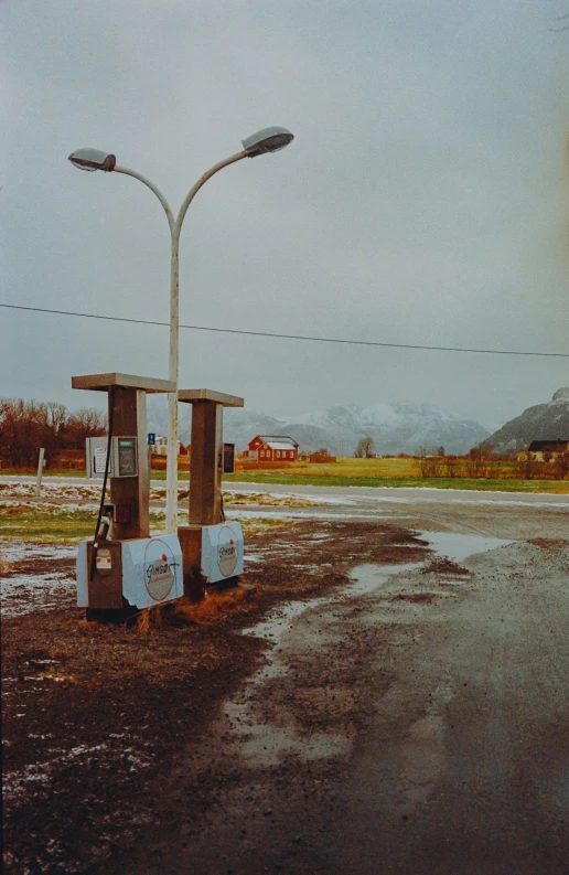 two street lights next to a dle with water