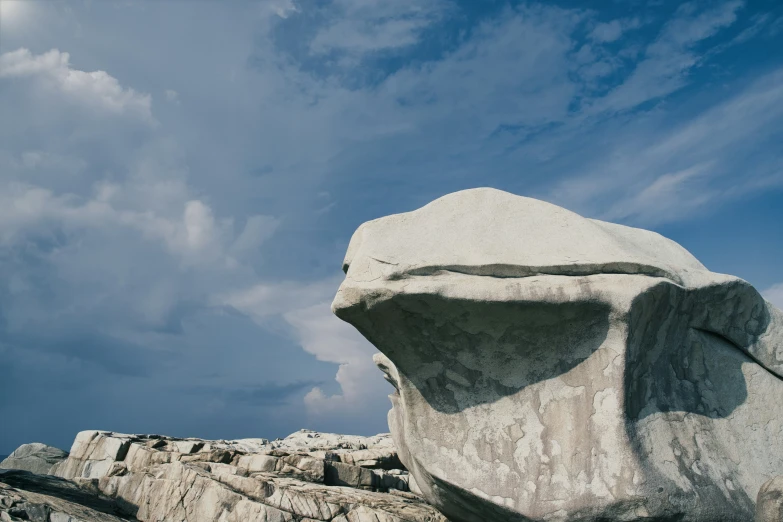 a giant rock sitting between some stone wall formations