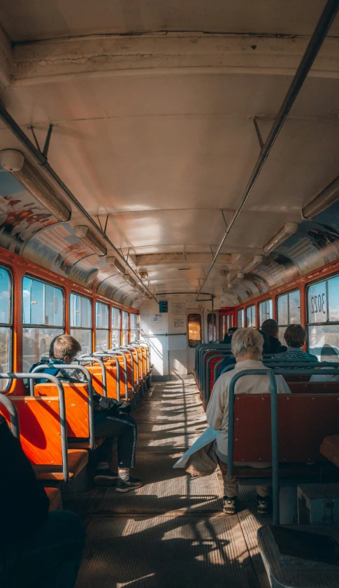 many people sitting in and near a bus window