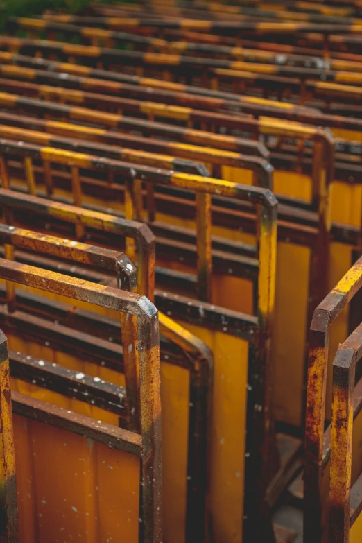 a group of yellow metal frames with rust on them