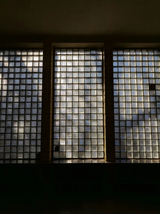 three windows are shown in this room covered with glass