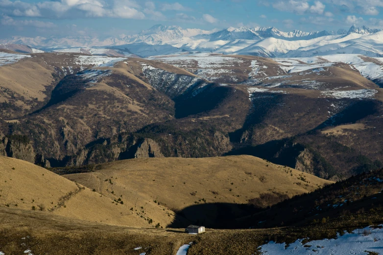 a mountain range covered in snow under a blue sky