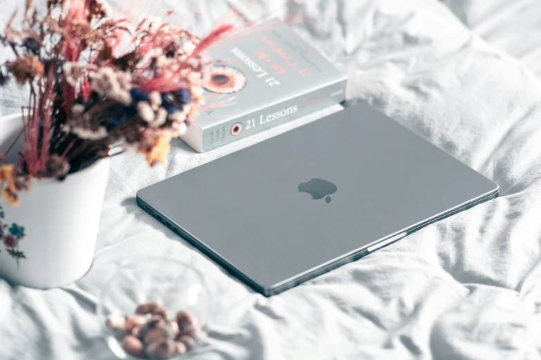 two books on top of a white bed