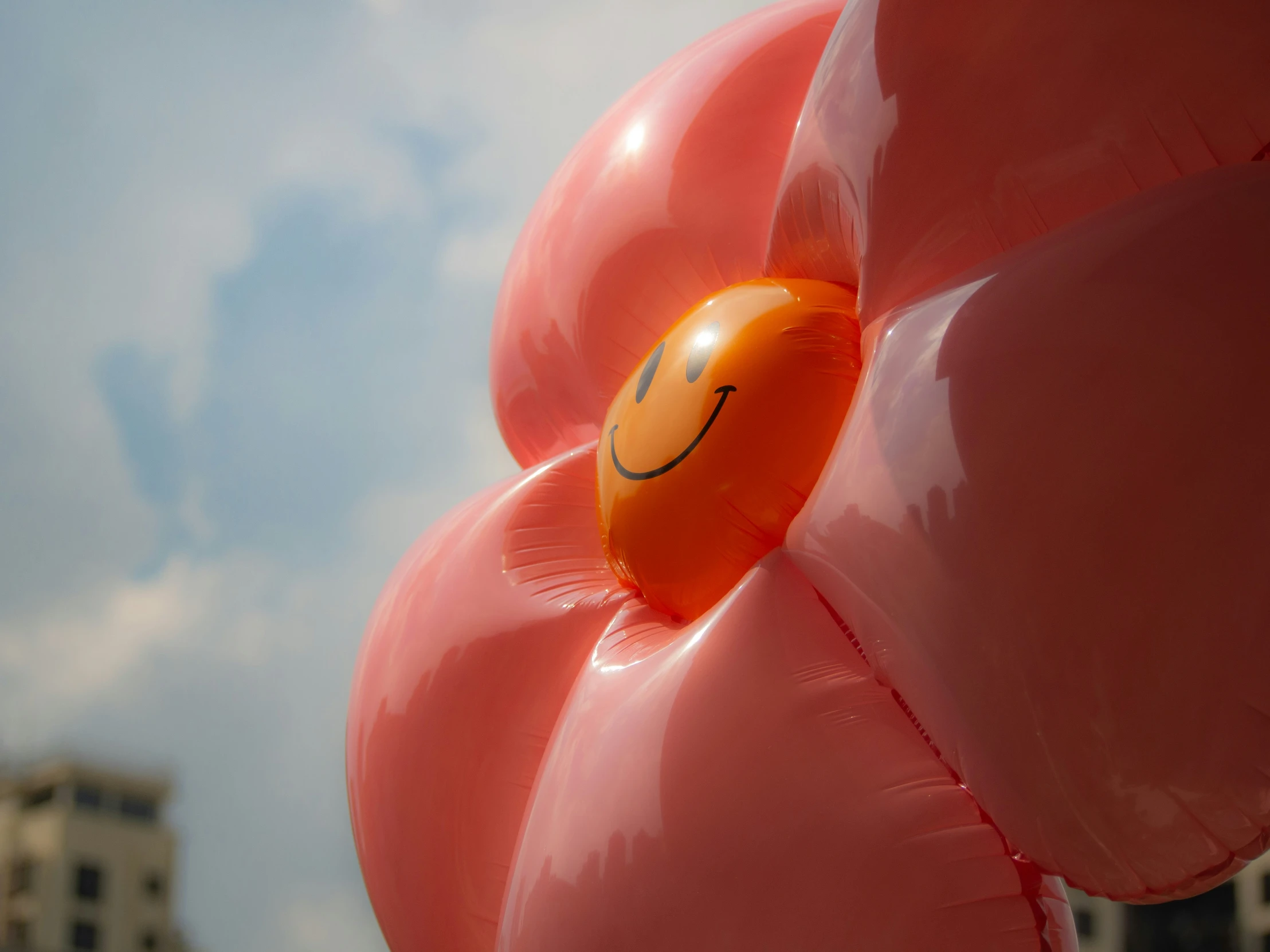 a large orange balloon with a smiley face on it