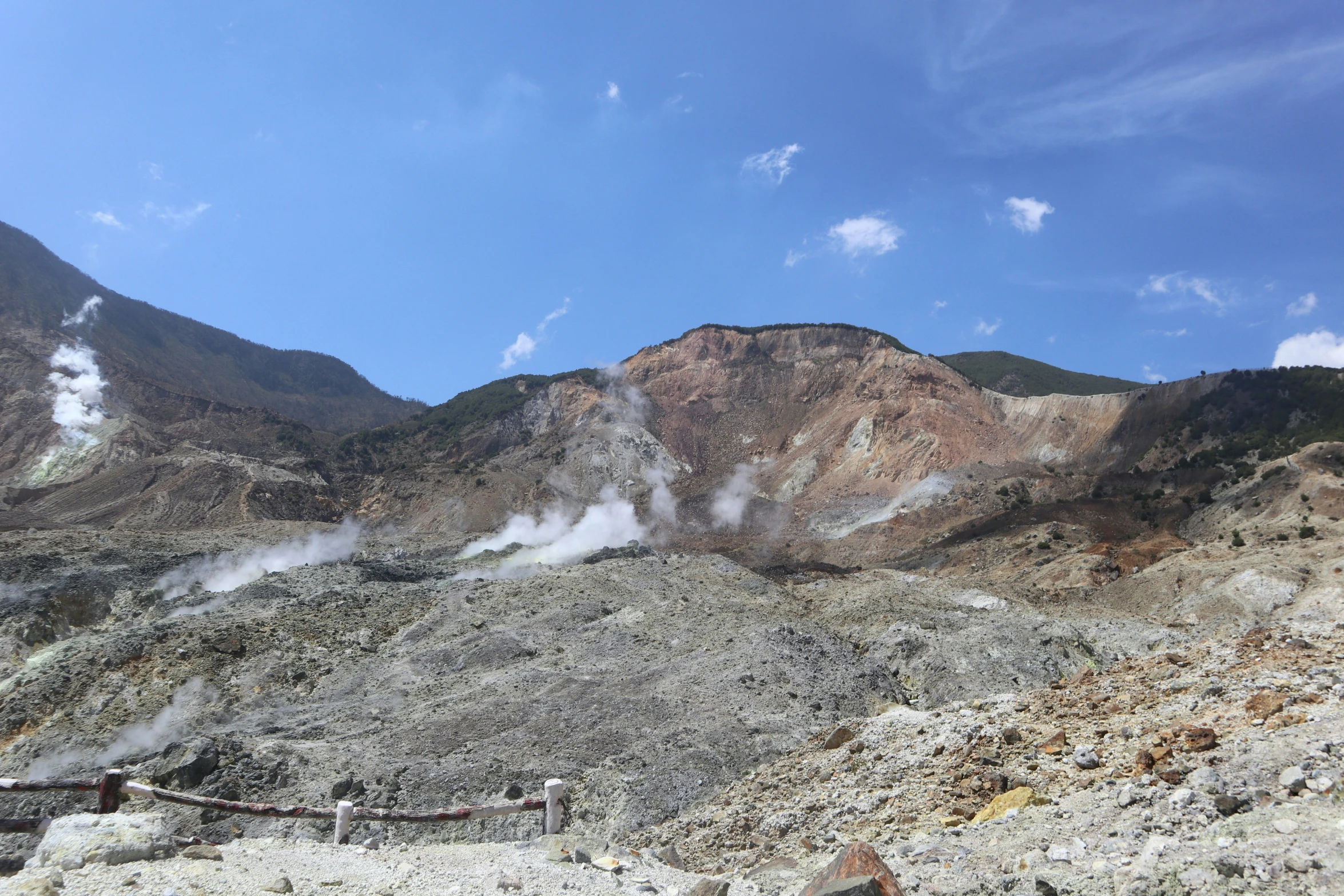 a scenic mountain scene with steam coming from it