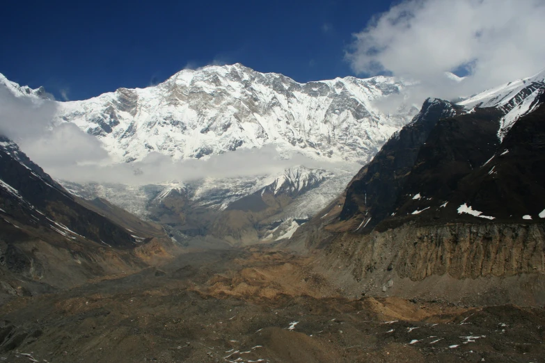 an aerial view of snowy mountains and valleys