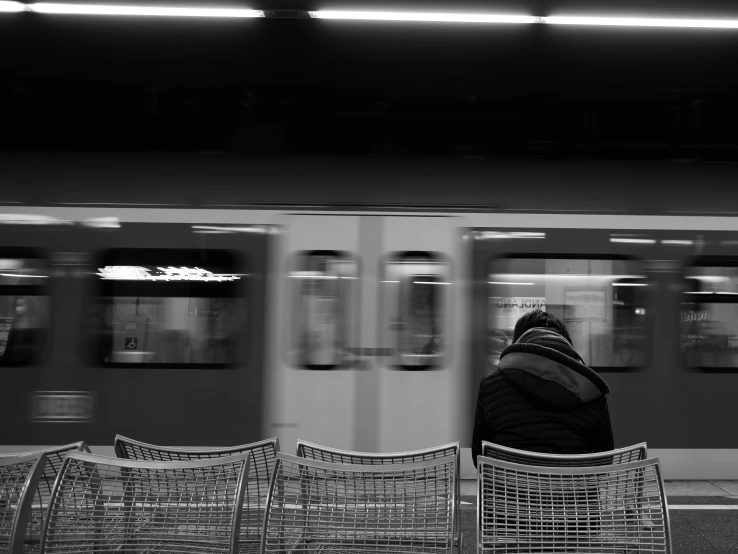 the woman is waiting in the train station