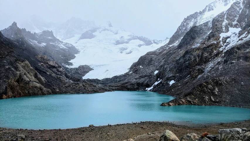 there is a blue lake that is near a mountain
