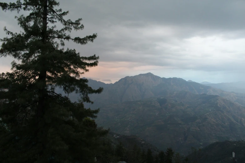 a scenic view of mountains and clouds in the distance