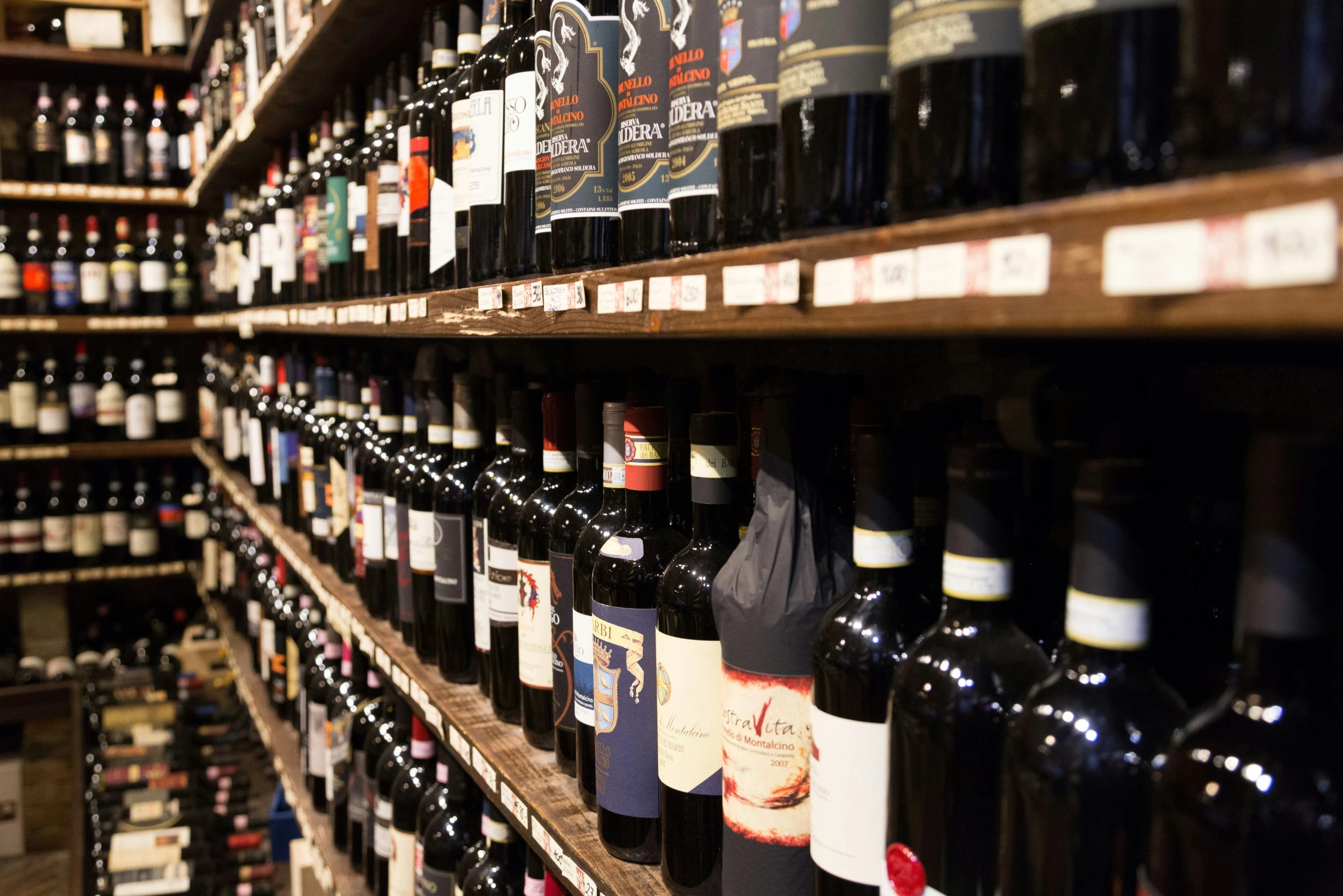 a number of bottles on a shelf near each other