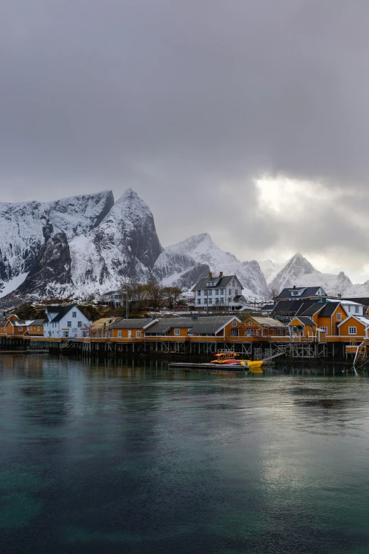 the view of a dock with boats and houses