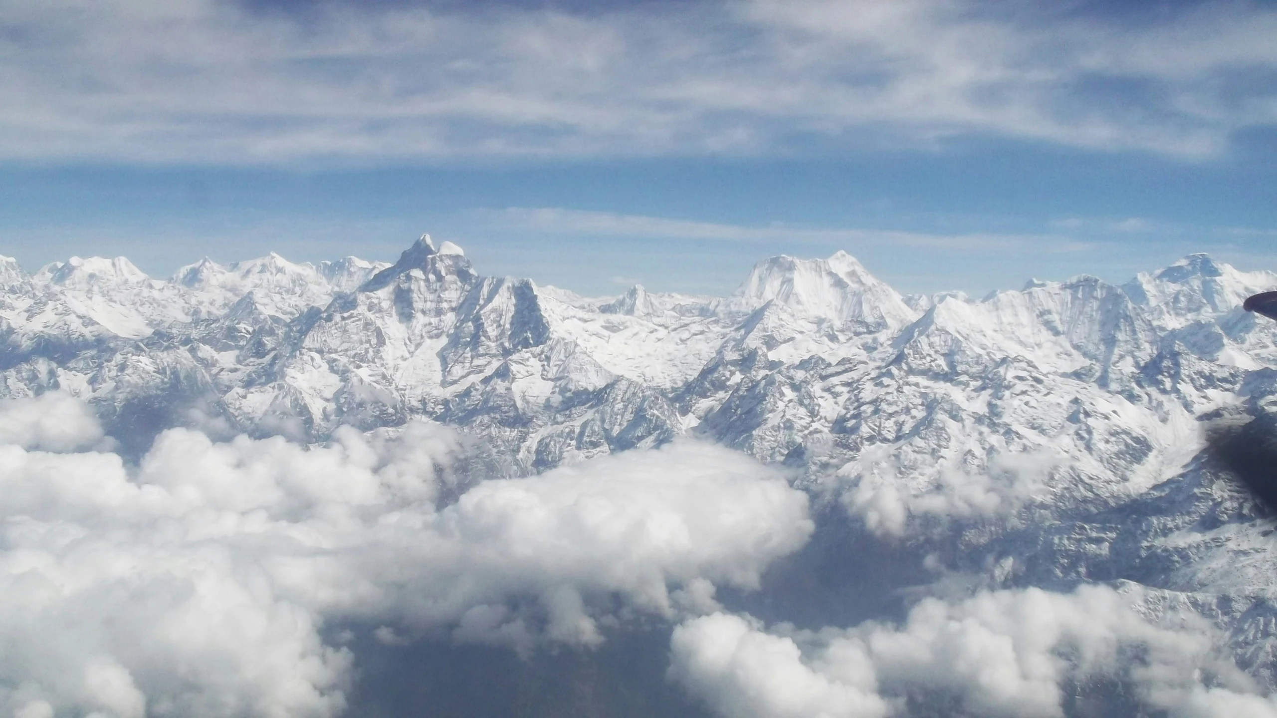 a mountain view with clouds flying above it