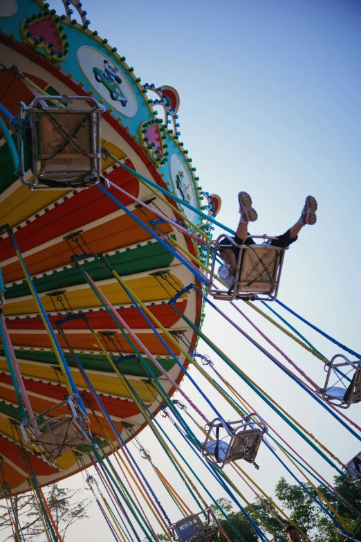 the person in the high chair is on the carnival rides