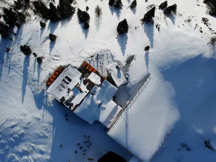 an aerial view of an all white house on the snow