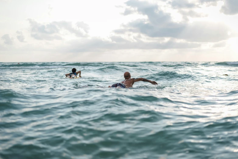 two people on surfboards in the ocean