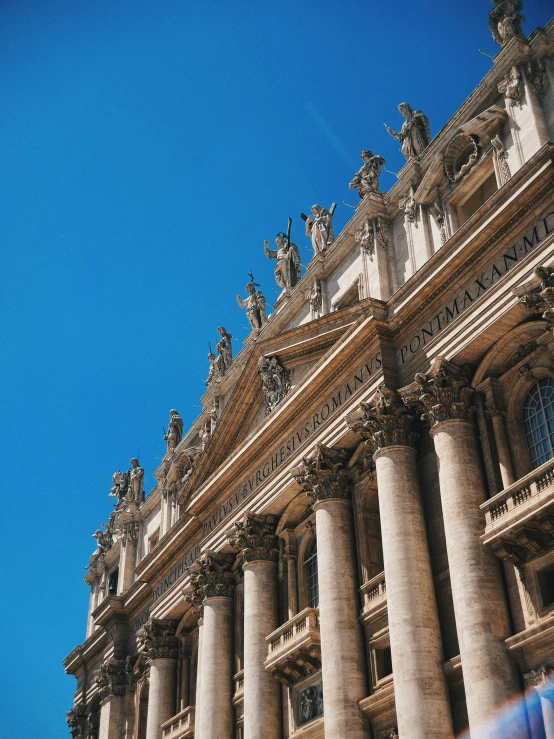 an old building with many statues on top