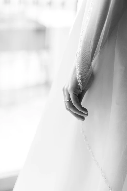 a woman's hand holds the back of her dress