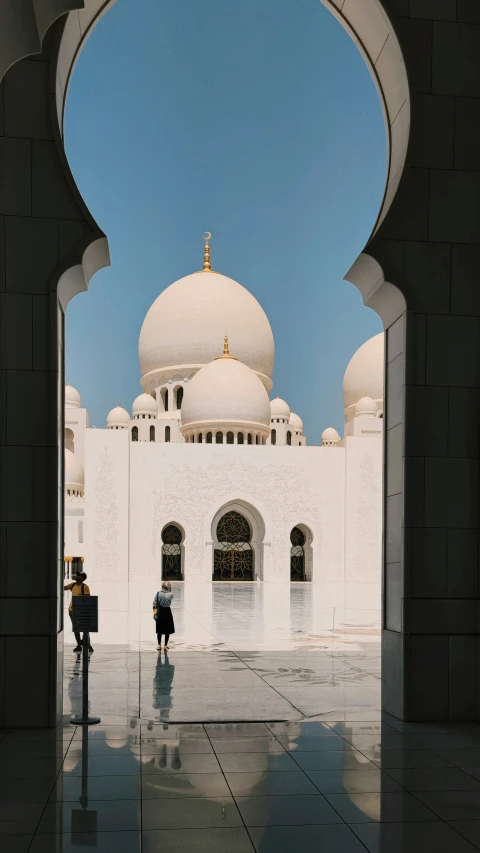 two people standing in front of a building