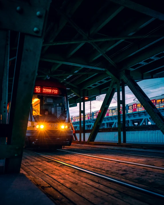 the train is on a railway tracks under a bridge