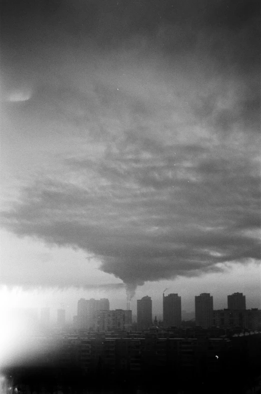 a black and white po of a skyline on a cloudy day