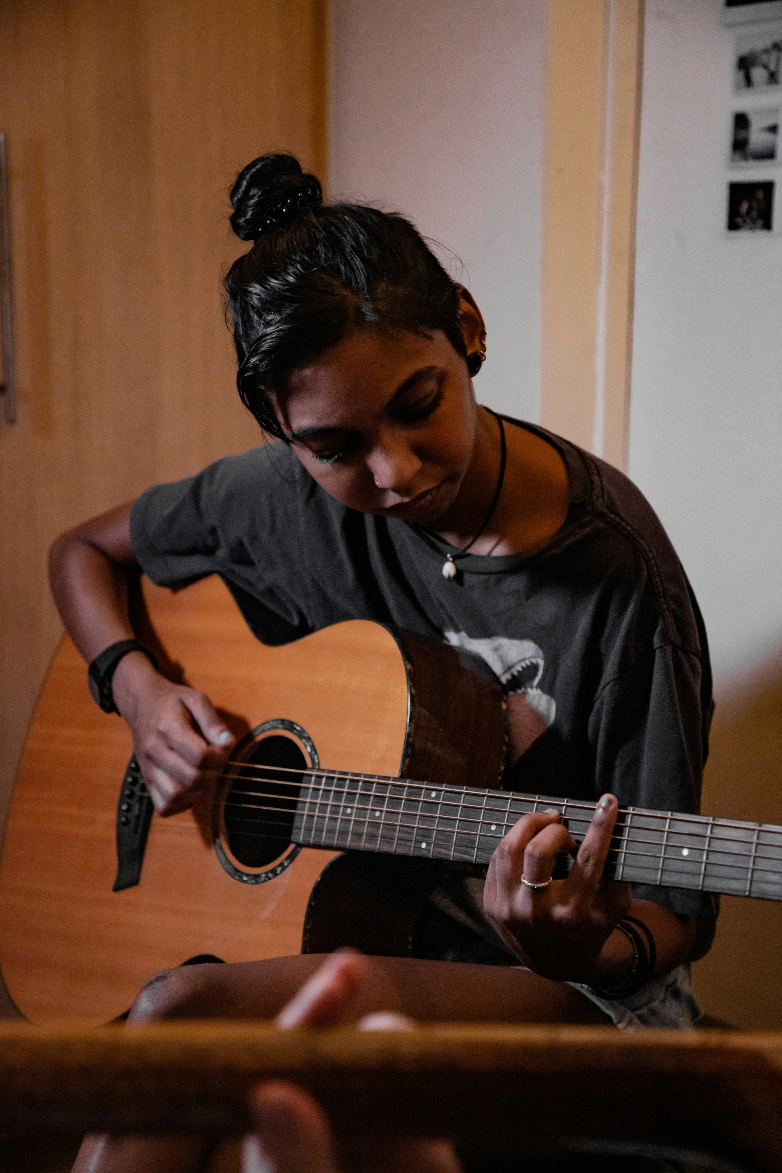 a woman holding an acoustic guitar in her hands