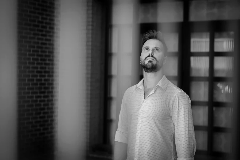 a man with a beard looking up and to the side