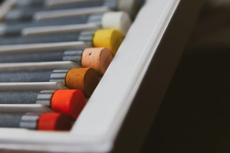 a long row of colored pencils on a table