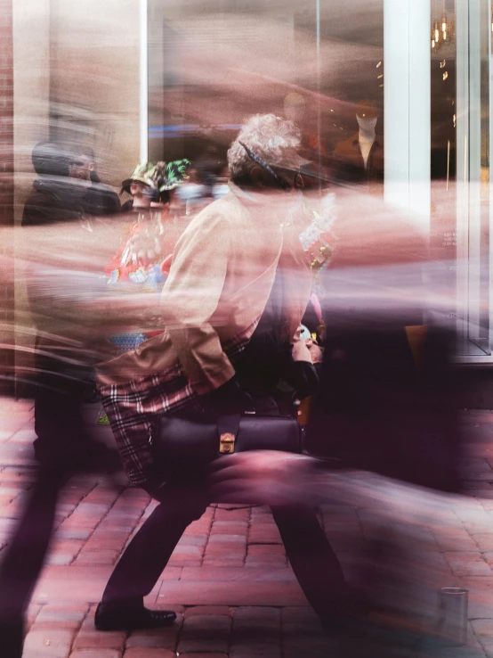 blurry image of woman walking on sidewalk by window