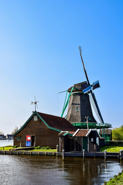 a windmill sitting in the middle of a lake