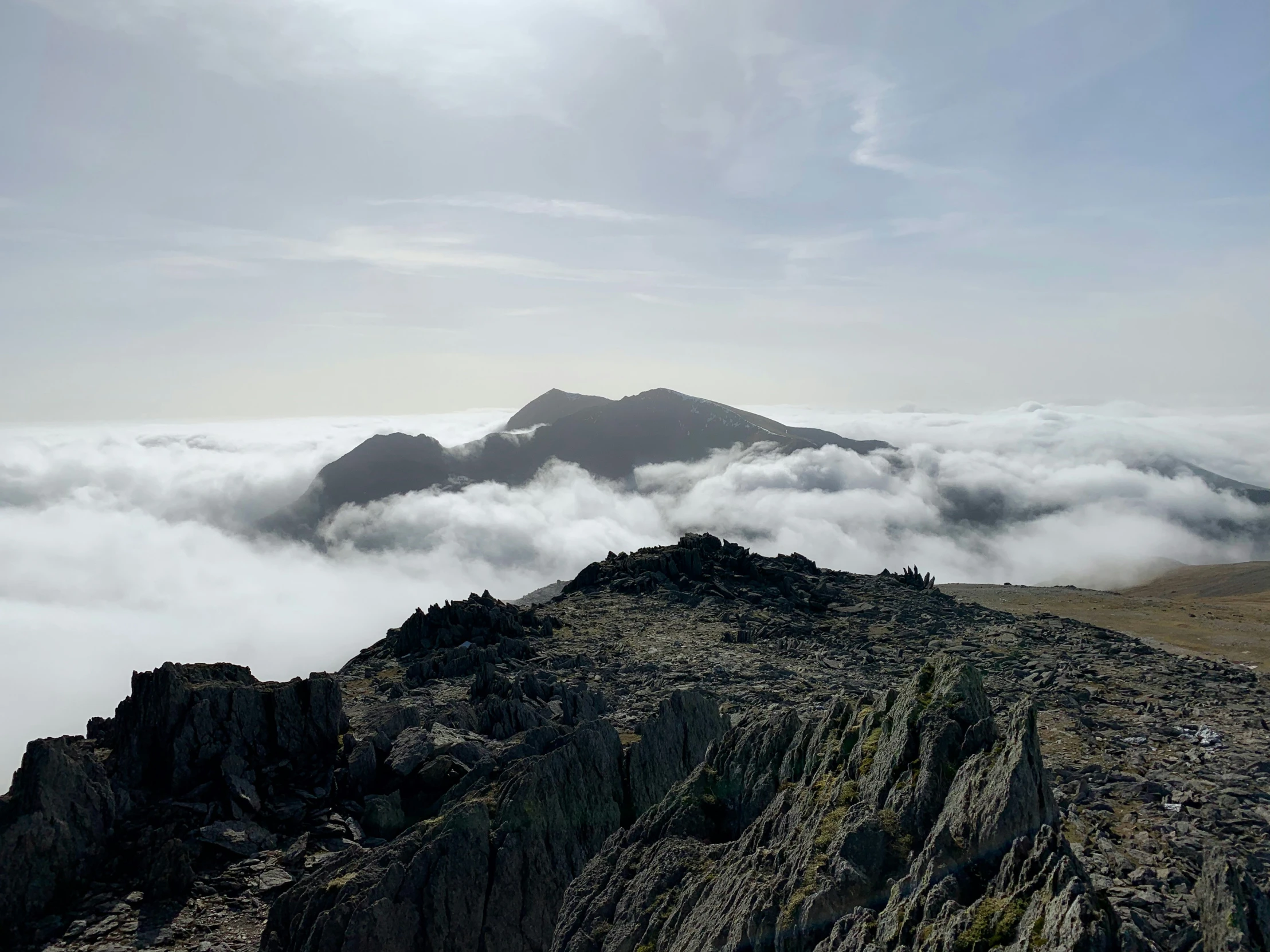 some mountain side with a very steep ridge above