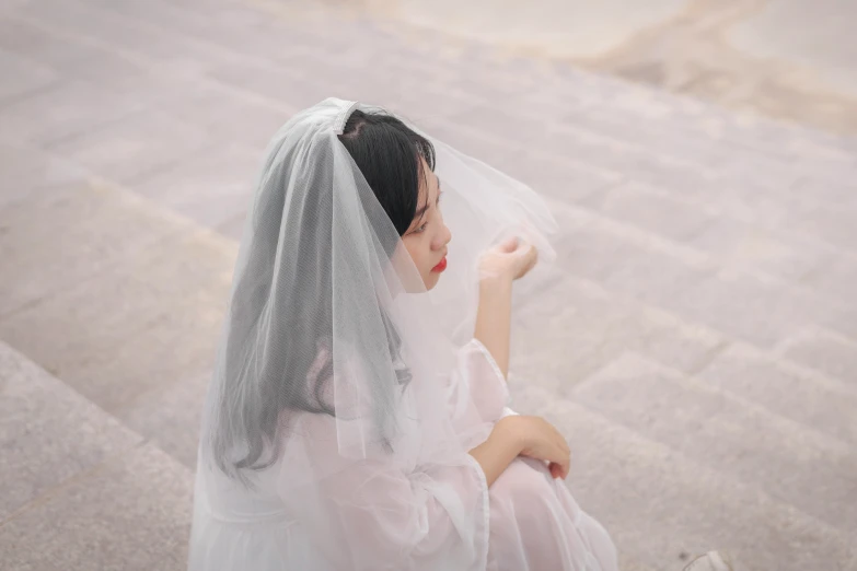 a woman wearing a wedding veil on her head
