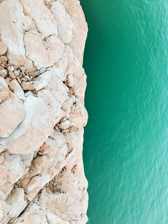 an aerial view of some rocks near water