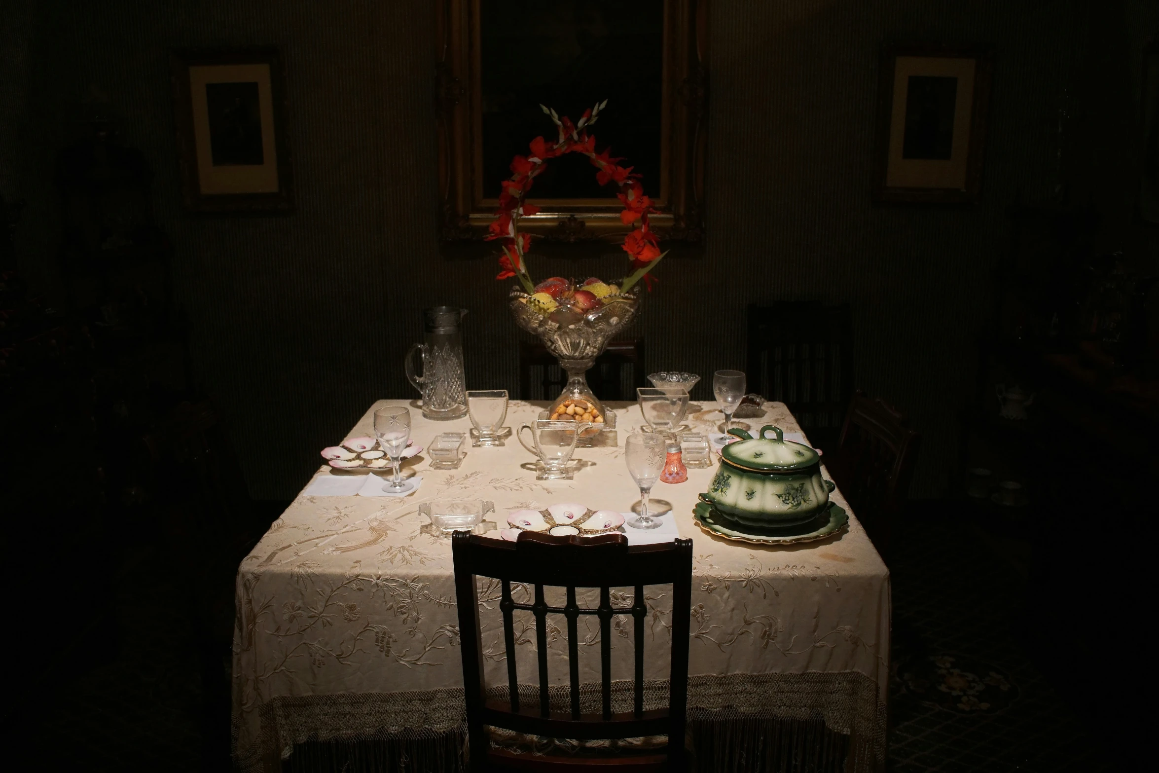 a table covered with a white table cloth and several glasses