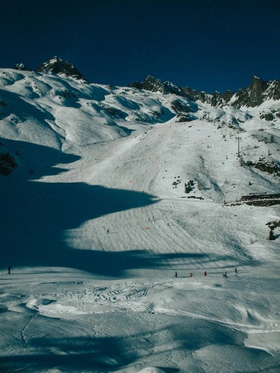 a snow covered ski slope with lots of skiers