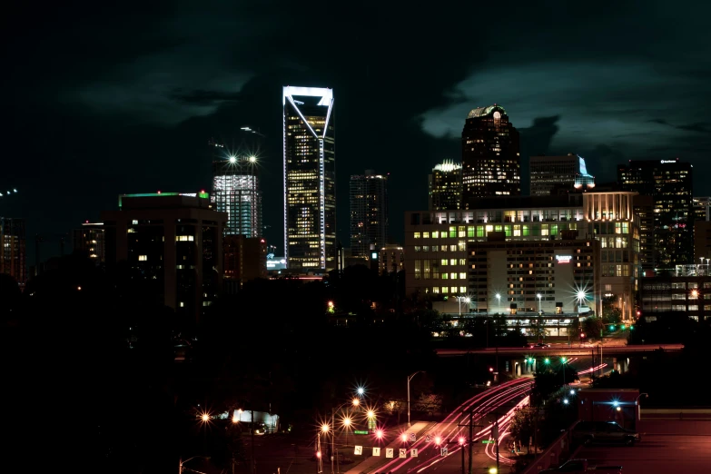 a night scene with a cityscape and a lot of traffic