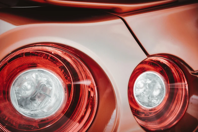 the taillights on a silver car look like they are from a car