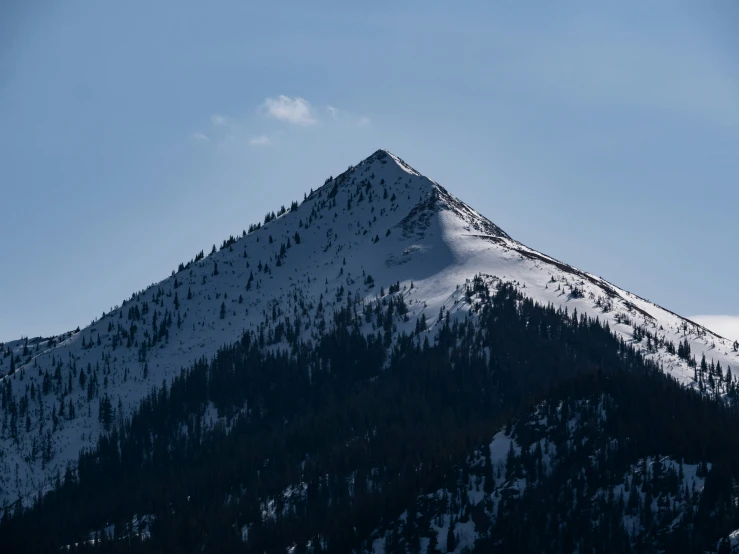 the top of a mountain is covered in snow