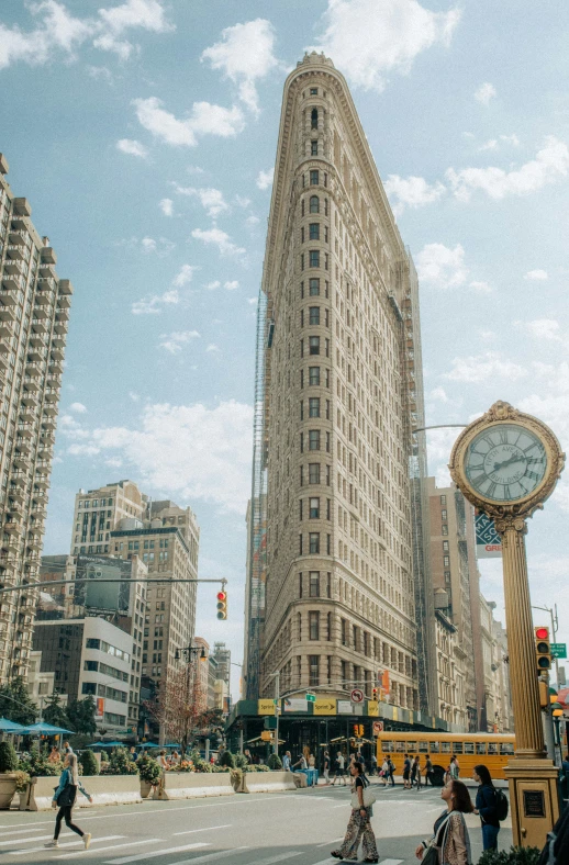 a large tall clock is in the middle of an intersection