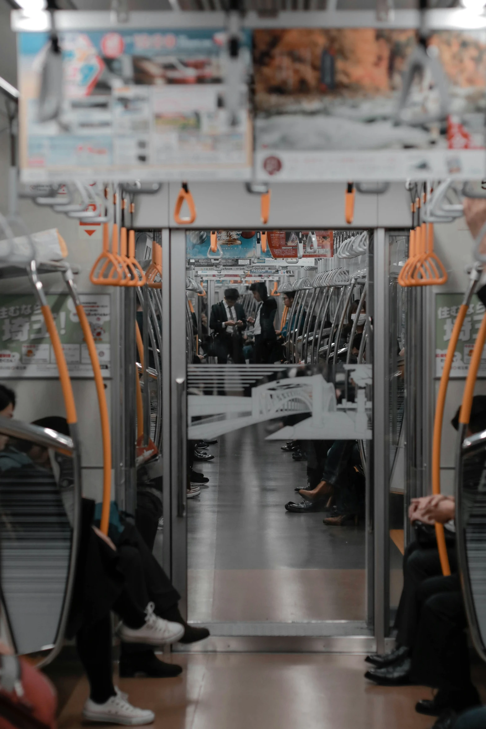 people riding on a train, one person is reading a book