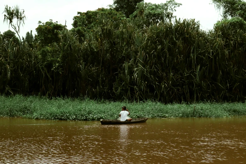 a person on a small boat in a body of water