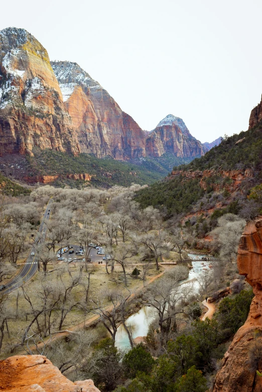 the view of a valley surrounded by mountains and trees