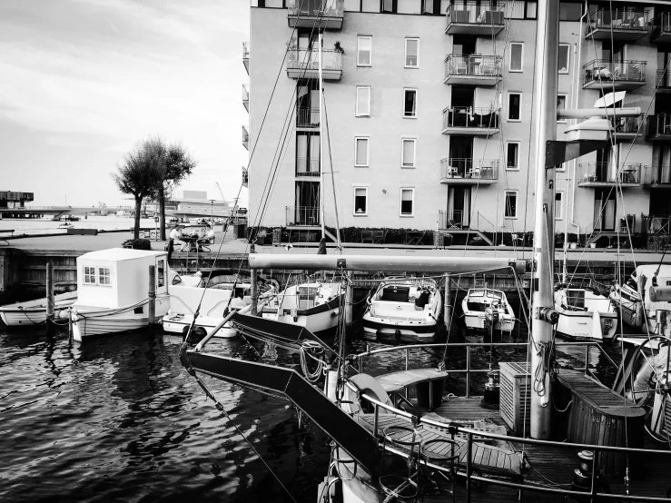 a number of boats parked in front of a tall building