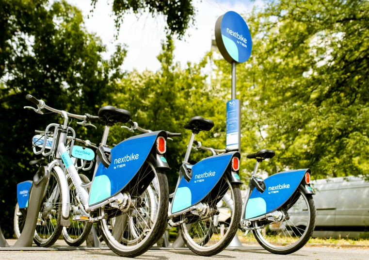 bicycles are lined up in a row by a sign