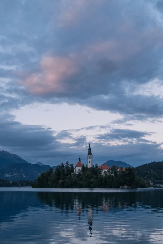 a church on a small island in the middle of a body of water