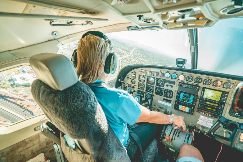 two pilots in the cockpit of an airplane with a view from inside