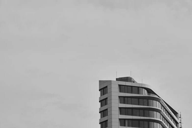 a large white building sitting under a cloudy sky