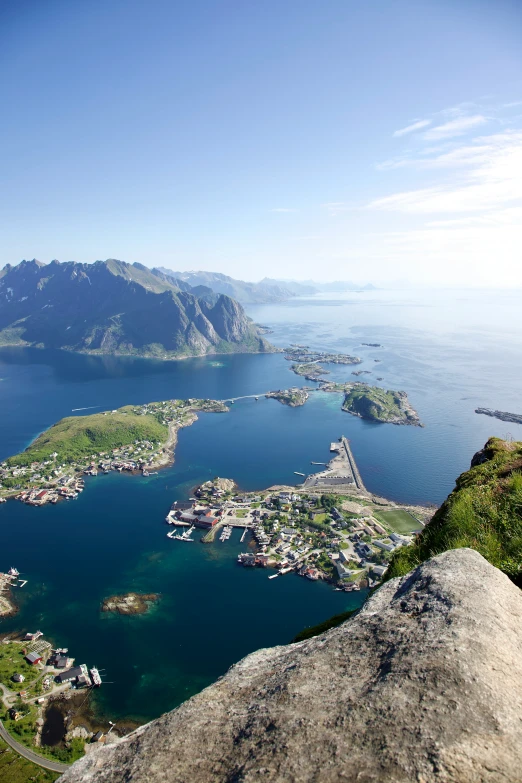 a view from the top of a mountain looking at a bay and a town