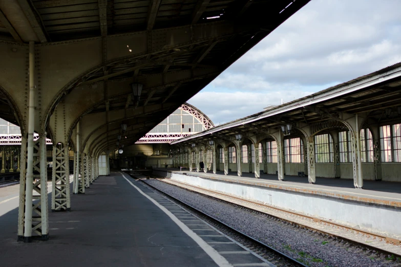 an empty train station with many trains on tracks