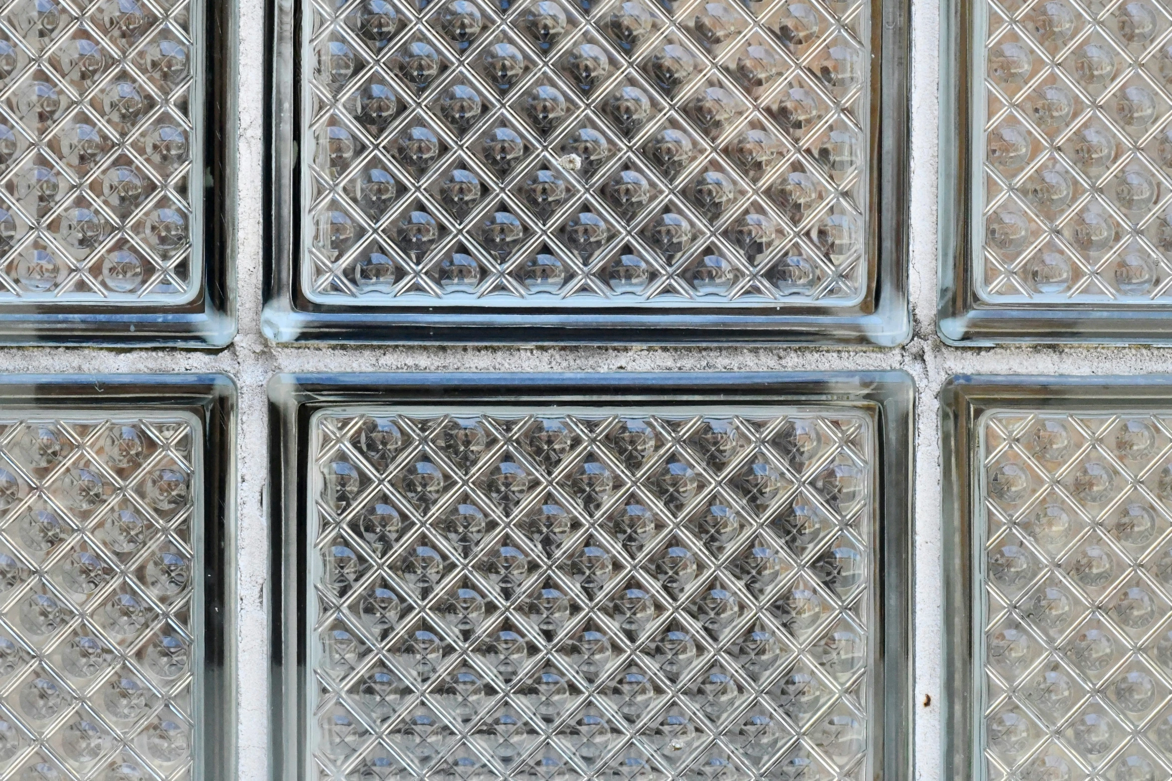 clear glass blocks, with the reflection of trees behind them